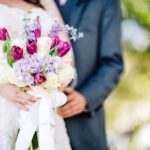 St. Petersburg Waterfront Bride and Groom Wedding Portrait with Colorful Bouquet