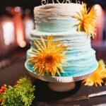 Three Tiered, Round Turquoise Blue Ombre Wedding Cake with Orange Flowers and Monogrammed Initial Cake Topper