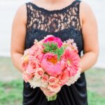 St. Pete Bridesmaid in Navy Blue Bridesmaids Dress and Bright Coral and Pink Wedding Bouquet of Flowers