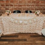 Rustic Bohemian Wedding Reception Bride and Groom Sweetheart Table with Blush Floral Linen, White Lily and Pink Rose Bouquets, and Brown Paper Mr and Mrs Banner | Downtown St Pete Wedding Venue NOVA 535