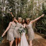 Bridesmaids in metallic lace dresses