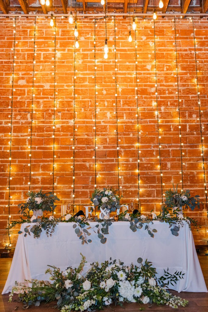 String Light Backdrop for Elegant White and Greenery Wedding Reception Sweetheart Table Decor Ideas | Tampa Bay Event Venue Nova 535