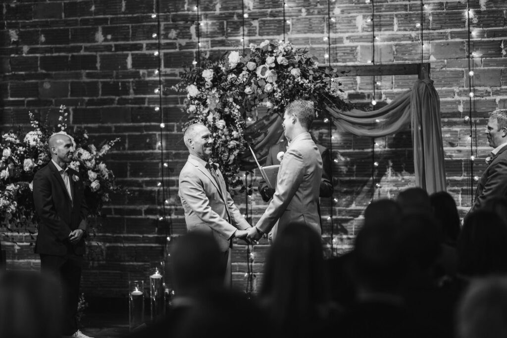 Elegant Dusty Blue Ceremony Decor with Draped Arch | NOVA 535 Industrial St Pete Wedding Venue with Brick Walls