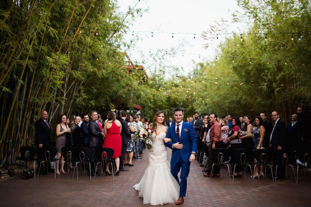 Wedding ceremony in bamboo gardens at NOVA 535 in St. Pete for a Industrial-Chic St. Pete Wedding 